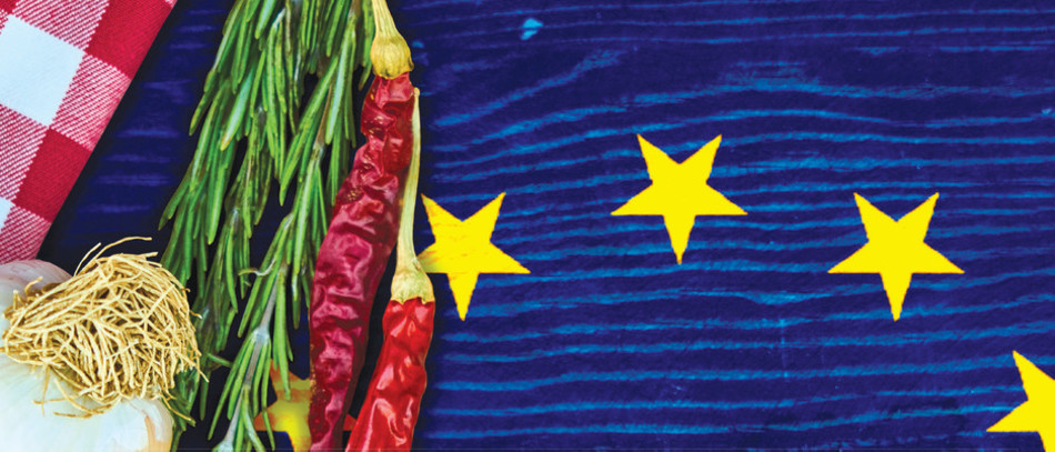 Légumes sur une table et morceau de drapeau européen en transparence.